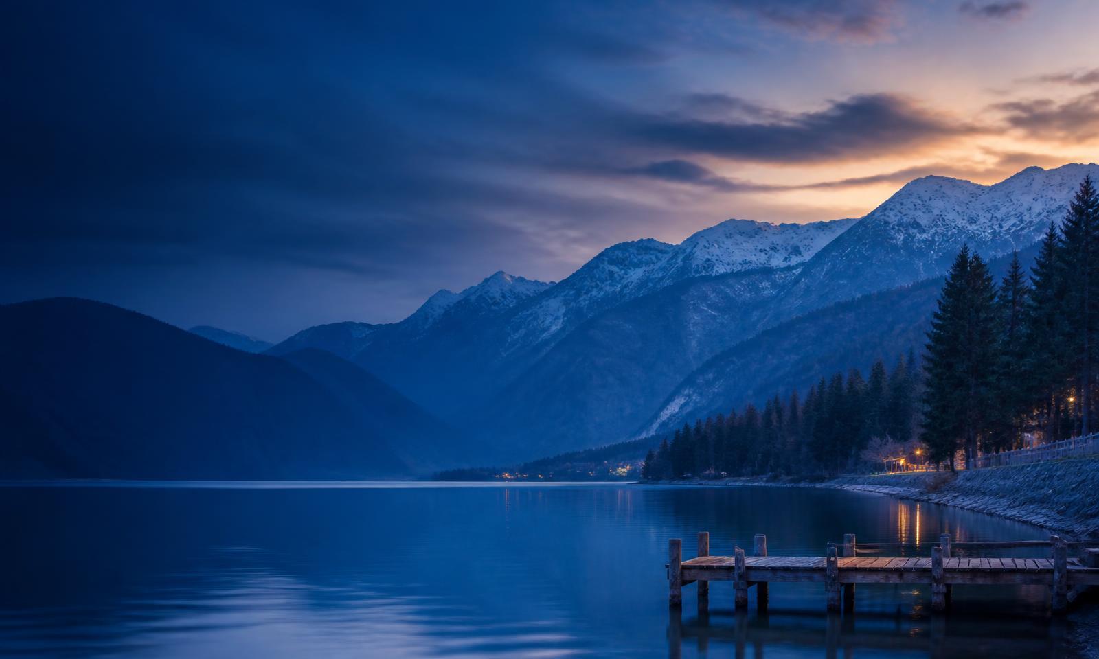 Snow-capped Himalayan mountains beside a calm lake in Kashmir
